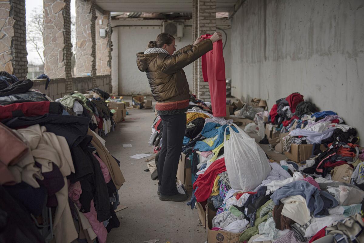 Woman looks at clothes in maternity hospital in Ukraine