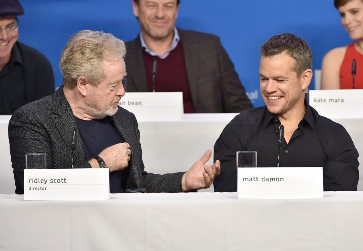 "The Martian" director Ridley Scott and star Matt Damon joke about something -- probably potatoes -- during a news conference for the the sci-fi survival film in Toronto.