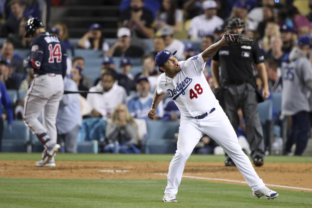Dodgers relief pitcher Brusdar Graterol celebrates after striking out Atlanta's Adam Duvall.