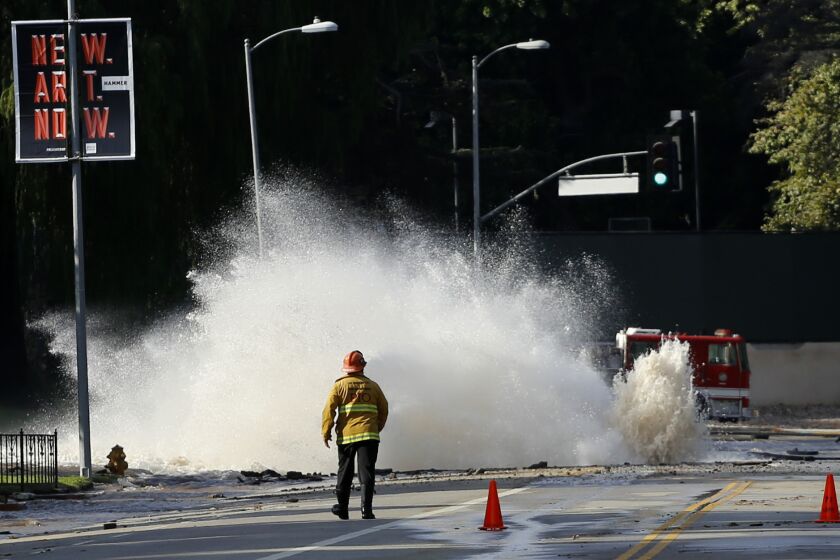 Water gushes from a broken pipe on Sunset Boulevard near UCLA in July 2014, flooding portions of the campus.