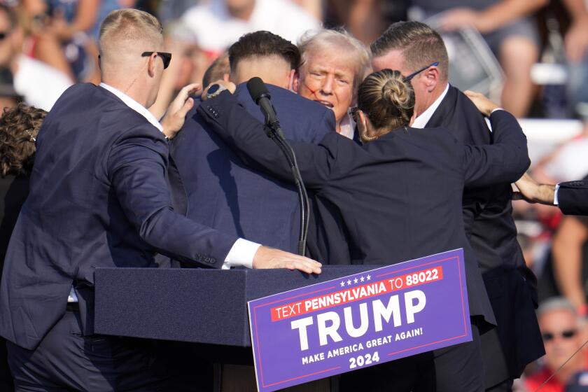 Republican presidential candidate former President Donald Trump is surrounded by U.S. Secret Service at a campaign event in Butler, Pa., on Saturday, July 13, 2024. (AP Photo/Gene J. Puskar)