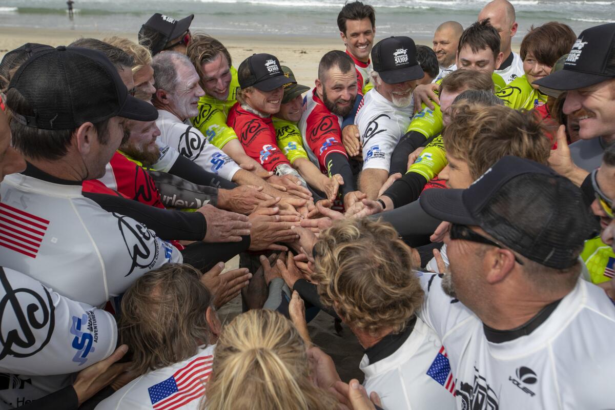 Wounded veterans join surf instructors and volunteers in the "Mayan handshake", an exercise on sharing space, before heading to the water.