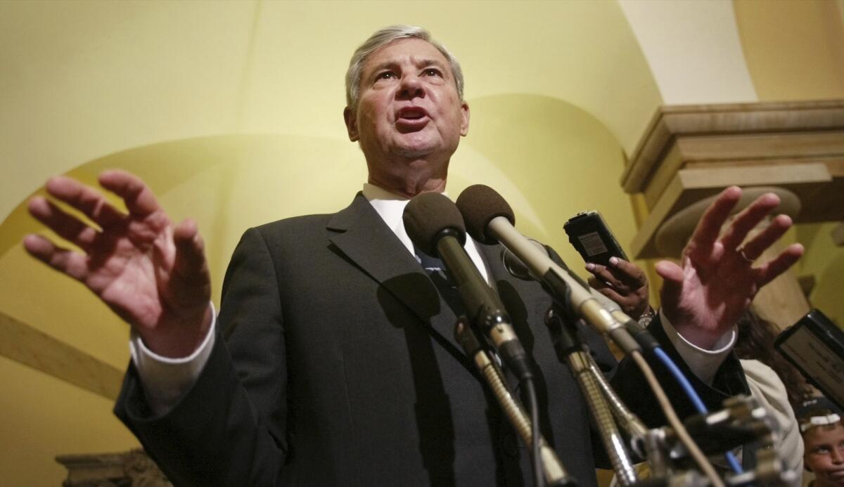 Then-Senator Bob Graham speaks into microphones in the U.S. Capitol