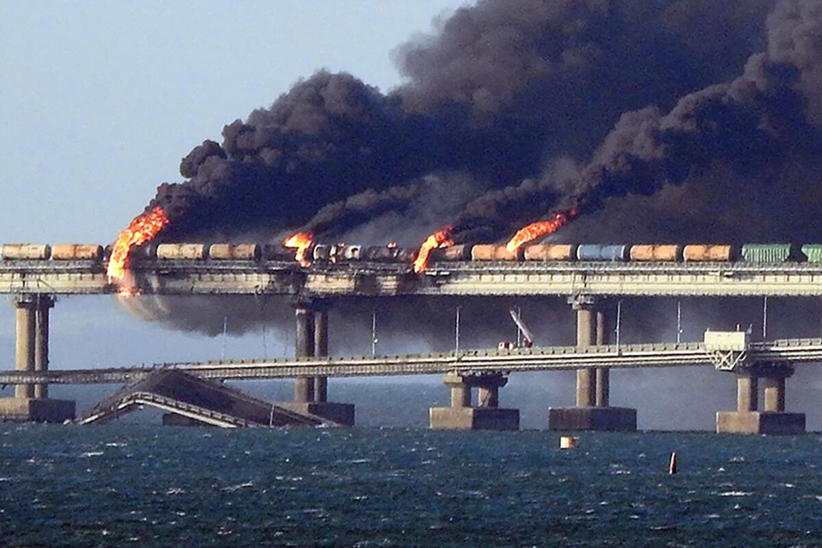 Black smoke billows from a fire on the Kerch bridge