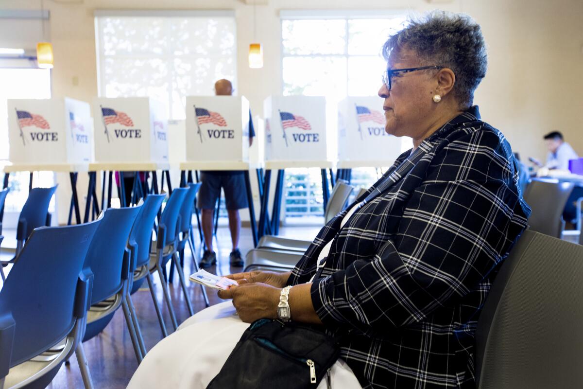 Jacqueline Purdy of Inglewood waits for her turn to vote early at the East Los Angeles Library on Oct. 27.