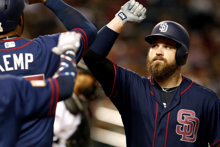 Padres catcher Derek Norris celebrates with teammates after hitting a home run during a game against the Diamondbacks last season.