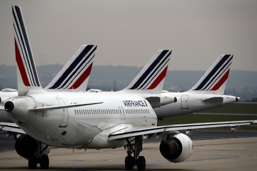 FILE - Air France planes are parked on the tarmac at Paris Charles de Gaulle airport, in Roissy, near Paris, on May 17, 2019. France's bureau that investigates air crashes and aviation safety said Wednesday it is looking into a "serious incident" involving an Air France flight from New York's JFK airport that suffered flight control problems on approach to its landing in Paris. (AP Photo/Christophe Ena, File)