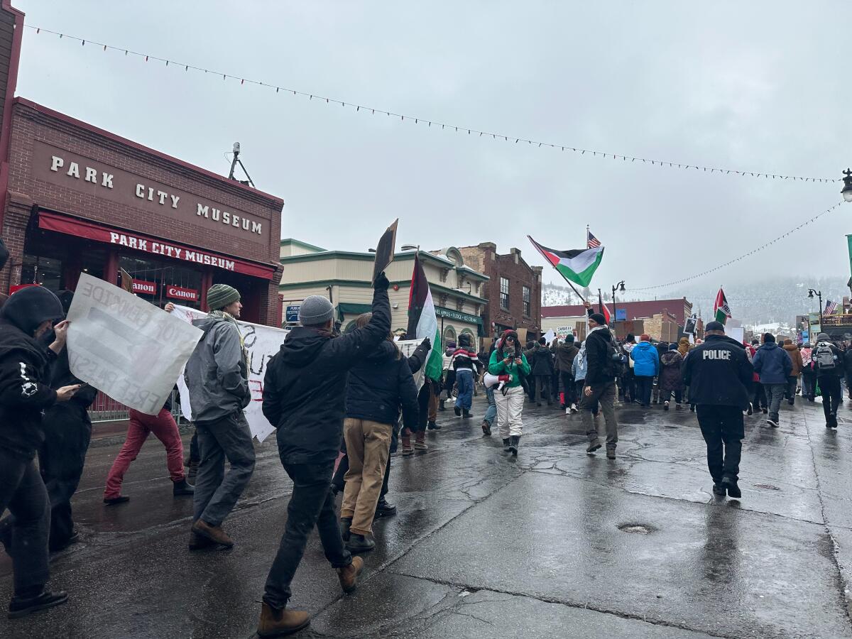 Protesters march down a street.