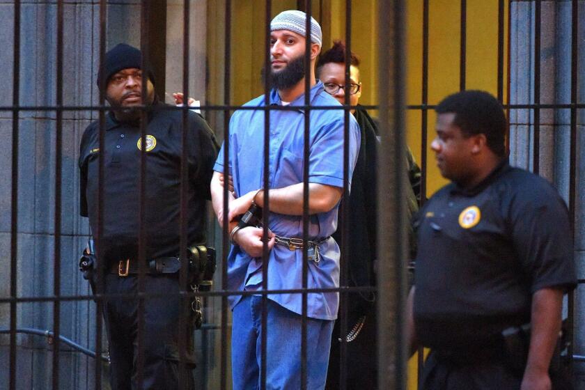 Officials escort "Serial" podcast subject Adnan Syed from the courthouse on Wednesday, Feb. 3, 2016 following the completion of the first day of hearings for a retrial in Baltimore, Md. (Karl Merton Ferron/Baltimore Sun/TNS) ** OUTS - ELSENT, FPG, TCN - OUTS **