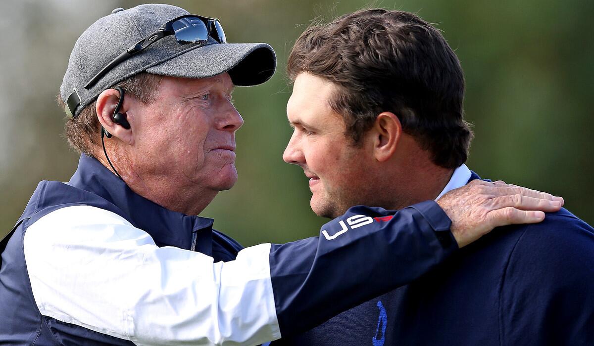 U.S. captain Tom Watson embraces Patrick Reed after he teamed with Jordan Speith to win a fourball competition against Europe's Ian Poulter and Stephen Gallagher on the first day of the Ryder Cup at Gleneagles.