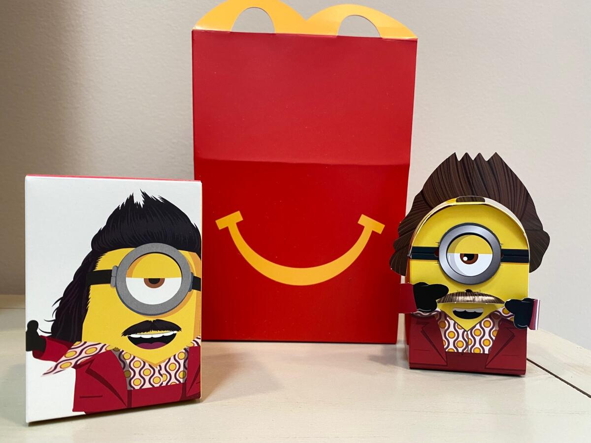 A cardboard McDonald’s Happy Meal toy with a Happy Meal box.