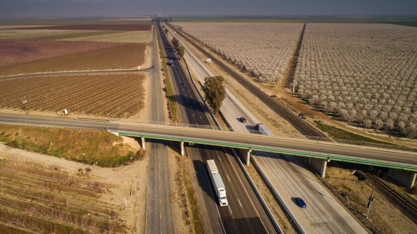 A California highway and fruit trees