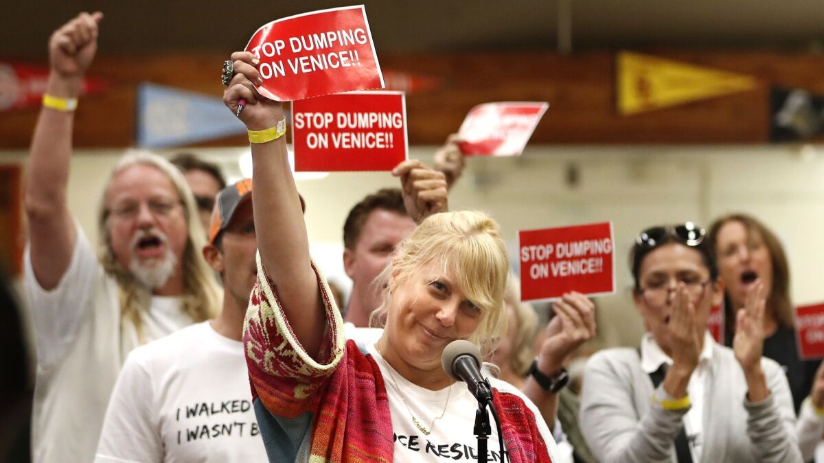 Dara Lasky, center, a 20-year Venice homeowner, joins others in voicing their opposition to plans for temporary homeless housing in Venice during the Oct. 17 town hall.