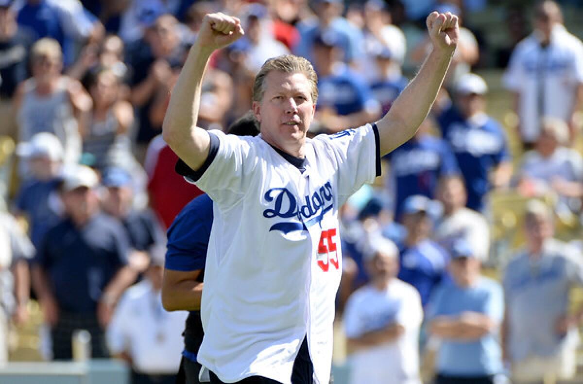 Former Dodgers pitcher Orel Hershiser reacts after throwing the ceremonial first pitch before Game 5 of the NLCS against the Cardinals on Oct. 16, 2013.