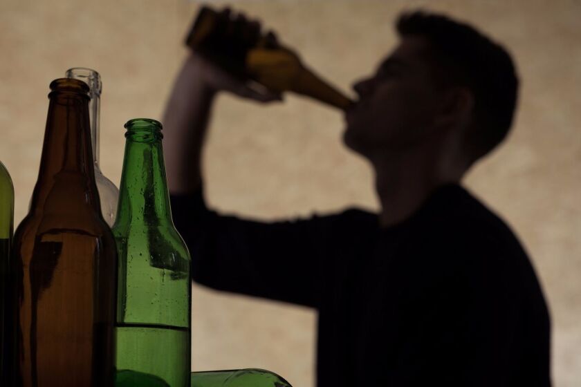 Alcoholism among young people - teenager drinking beer