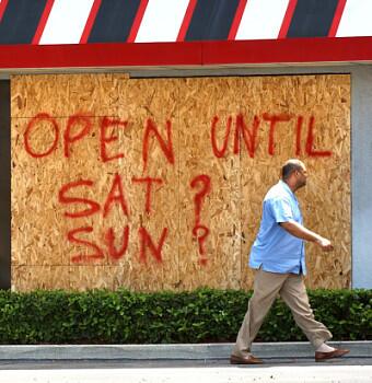Rennie Tarver walks past a sign at the Boston Market in Winter Park on Friday. Most stores will be closed today through Sunday or Monday.