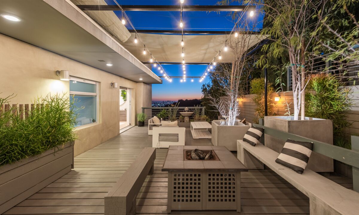 The two-story home features decks, balconies and patios that overlook the city below.