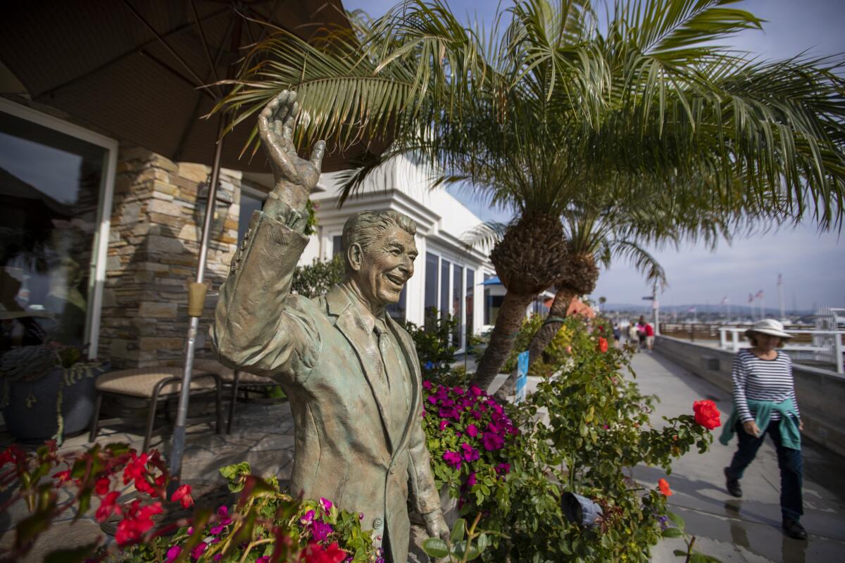 A statue of former President Ronald Reagan, an icon of Republican politics, adorns a Balboa Island waterfront home in Newport Beach in October.