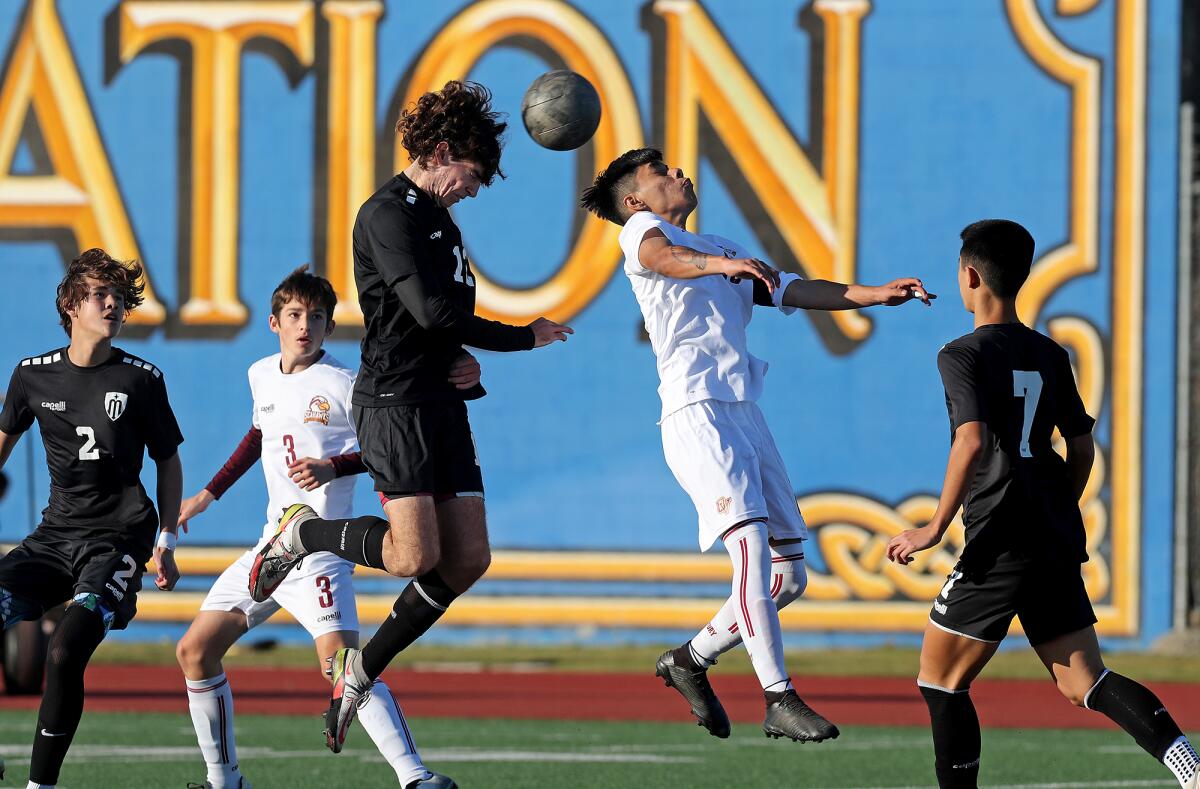 Marina's Tyler Hyde, left, goes up for a header against Ocean View's Jesse Camacho in a nonleague match.