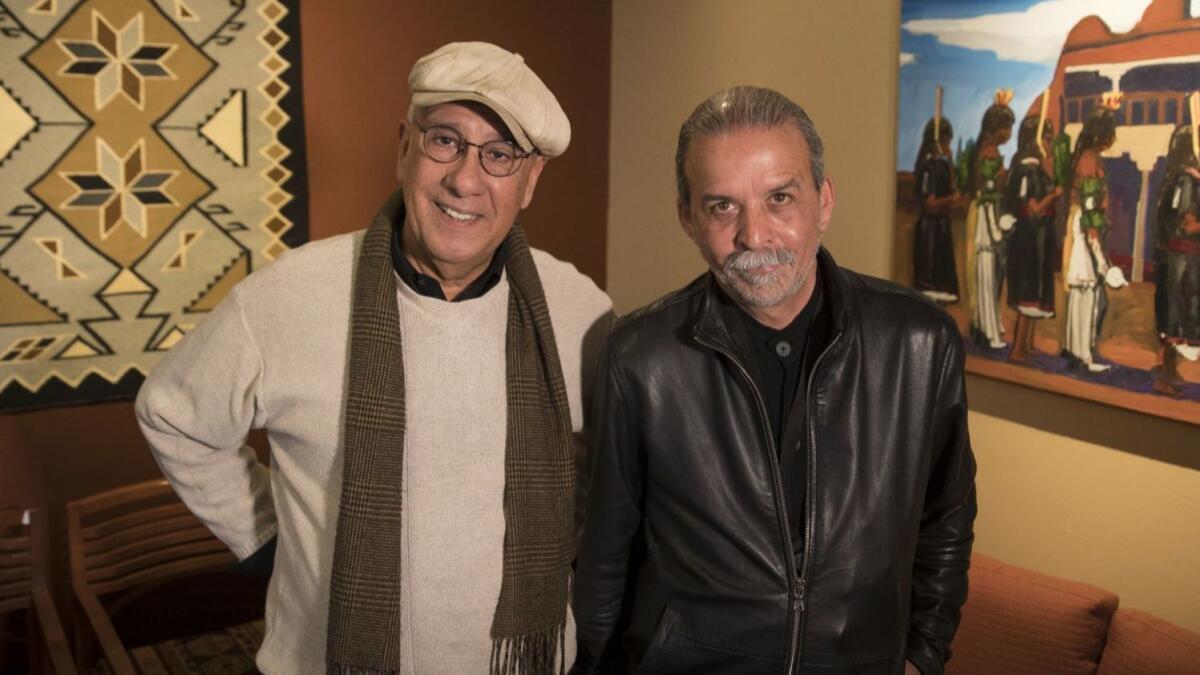 Photographer Luis Garza, left, and artist Harry Gamboa Jr. at the Autry Museum of the American West.