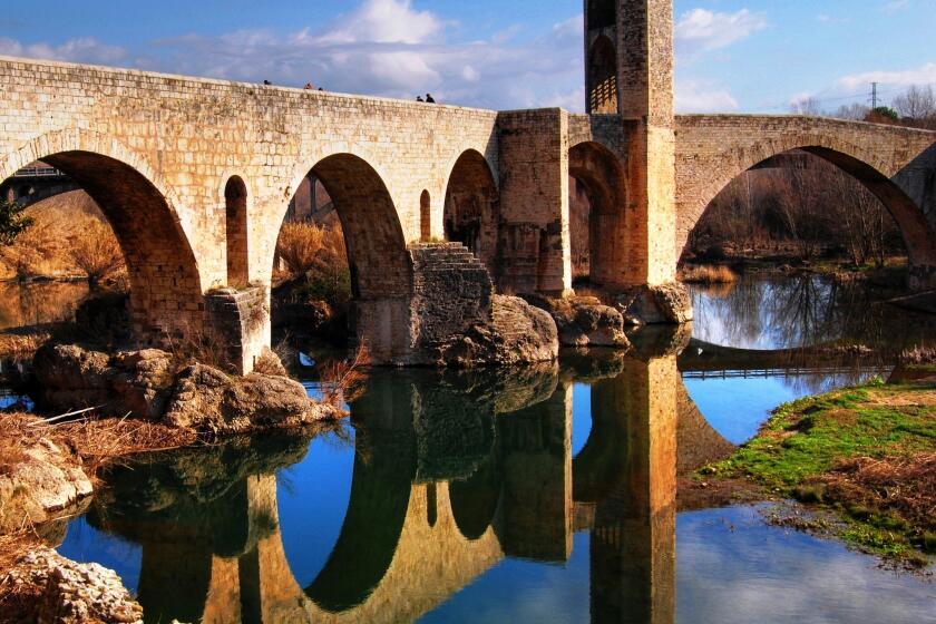 A fortified bridge from the 11th century leads into photogenic Besalu, Spain.