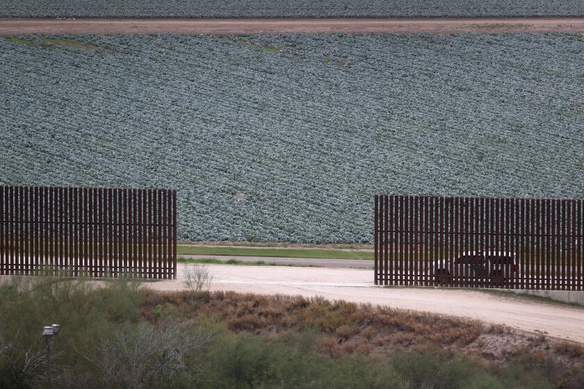 A U.S. Border Patrol vehicle waits at a fence opening near the U.S.-Mexico border in Texas.