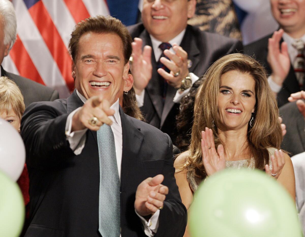 The-Gov. Arnold Schwarzenegger and then-wife Maria Shriver celebrate onstage with others