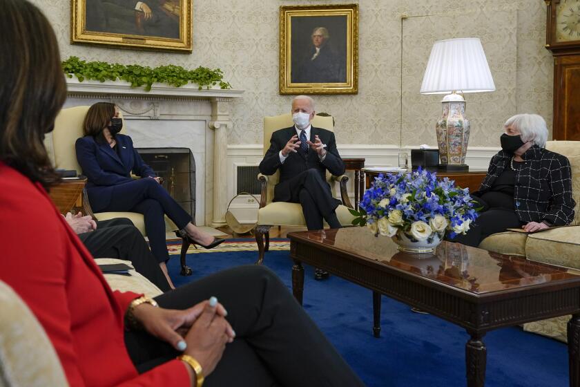 President Joe Biden, accompanied by Vice President Kamala Harris and Treasury Secretary Janet Yellen, meets with business leaders to discuss a coronavirus relief package in the Oval Office of the White House, Tuesday, Feb. 9, 2021, in Washington. (AP Photo/Patrick Semansky)