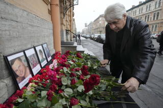 Vagif Mamishev lays flowers at a memorial site