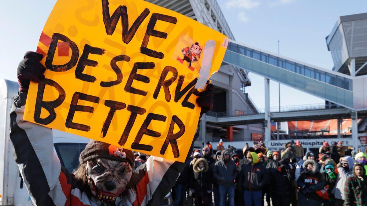 A Cleveland Browns fan holds up a sign during the "Perfect Season" parade on Saturday in Cleveland. The Browns became the second team in NFL history to lose 16 games in a season.