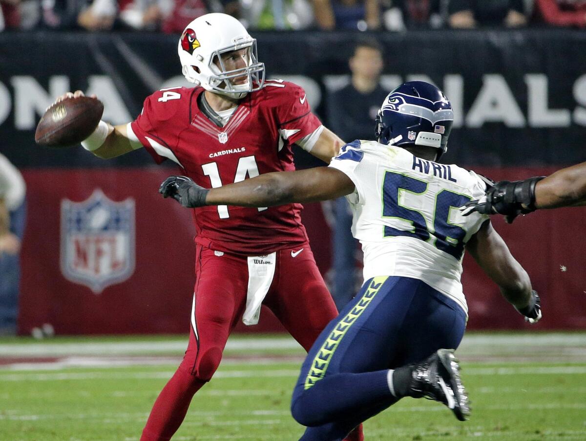 Cardinals quarterback Ryan Lindley passes under pressure from Seahawks defensive end Cliff Avril in the second half of their game last week.