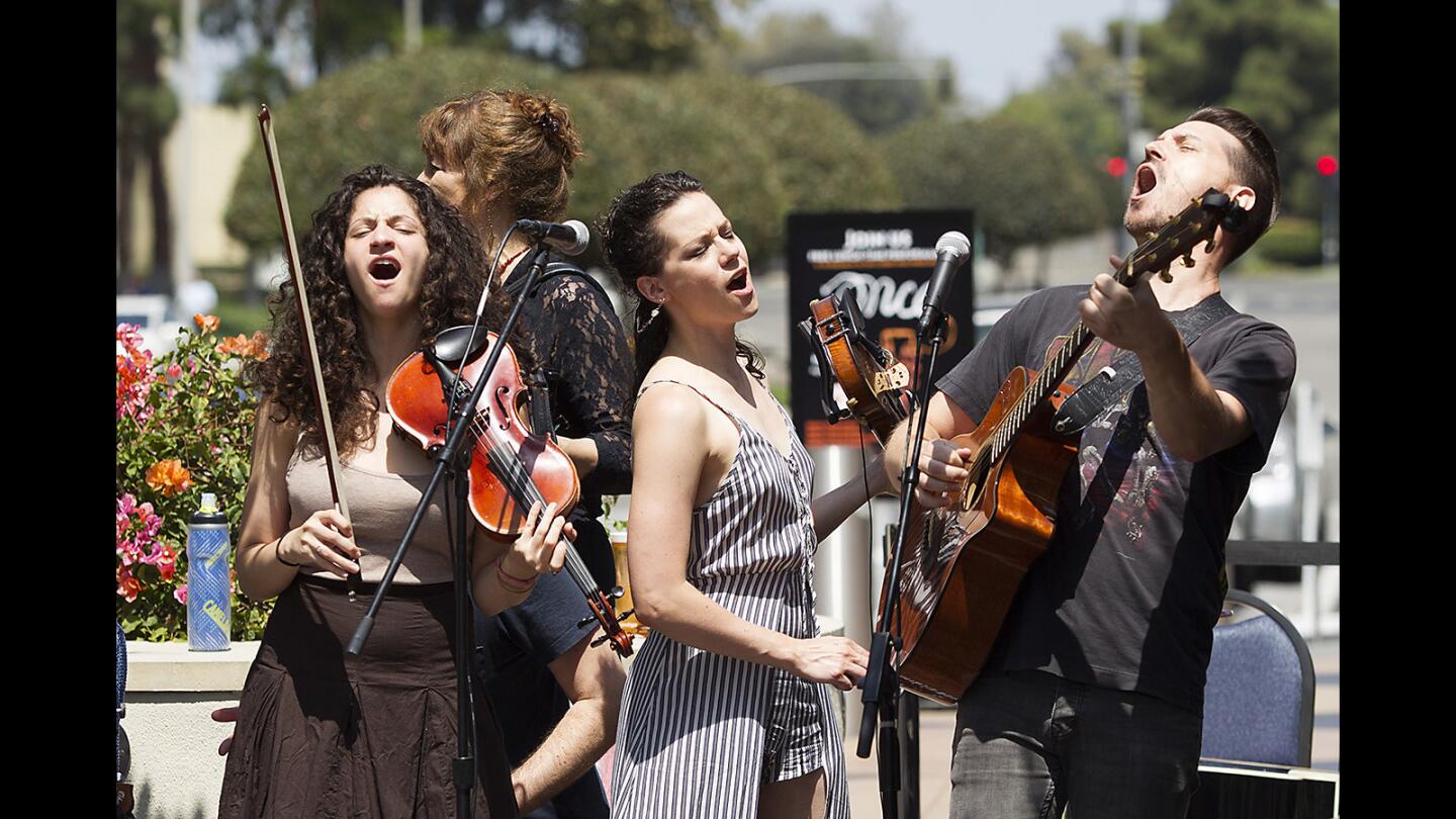 Cast members Marnina Schon, Cassidy Stirtz and Scott Anthony, from left, from the upcoming musical "Once" showcase their skills as rousing musicians during a noontime gig in front of South Coast Repertory on Wednesday.