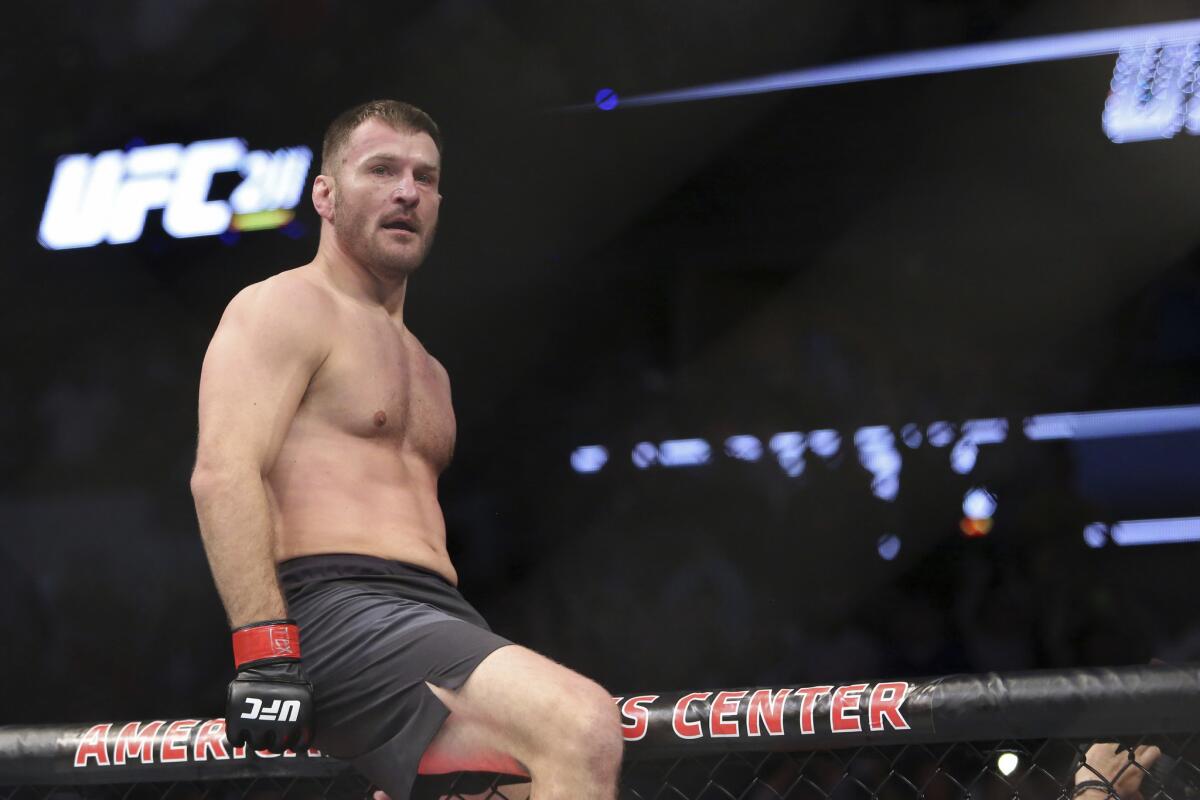 Stipe Miocic celebrates a win over Junior Dos Santos in a mixed martial arts bout at UFC 211 for the UFC heavyweight championship on May 13 in Dallas.