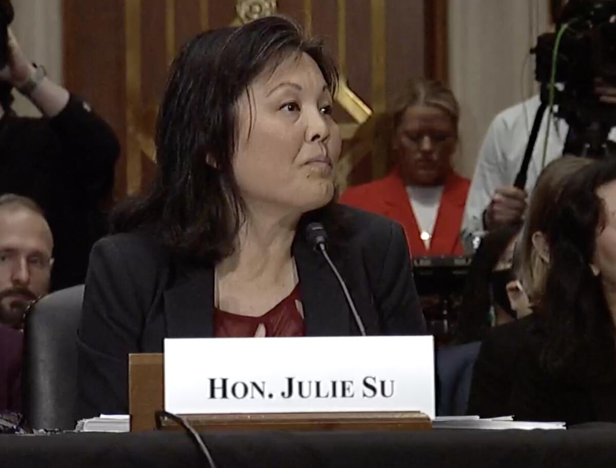 Julie Su listens to questions at a confirmation hearing