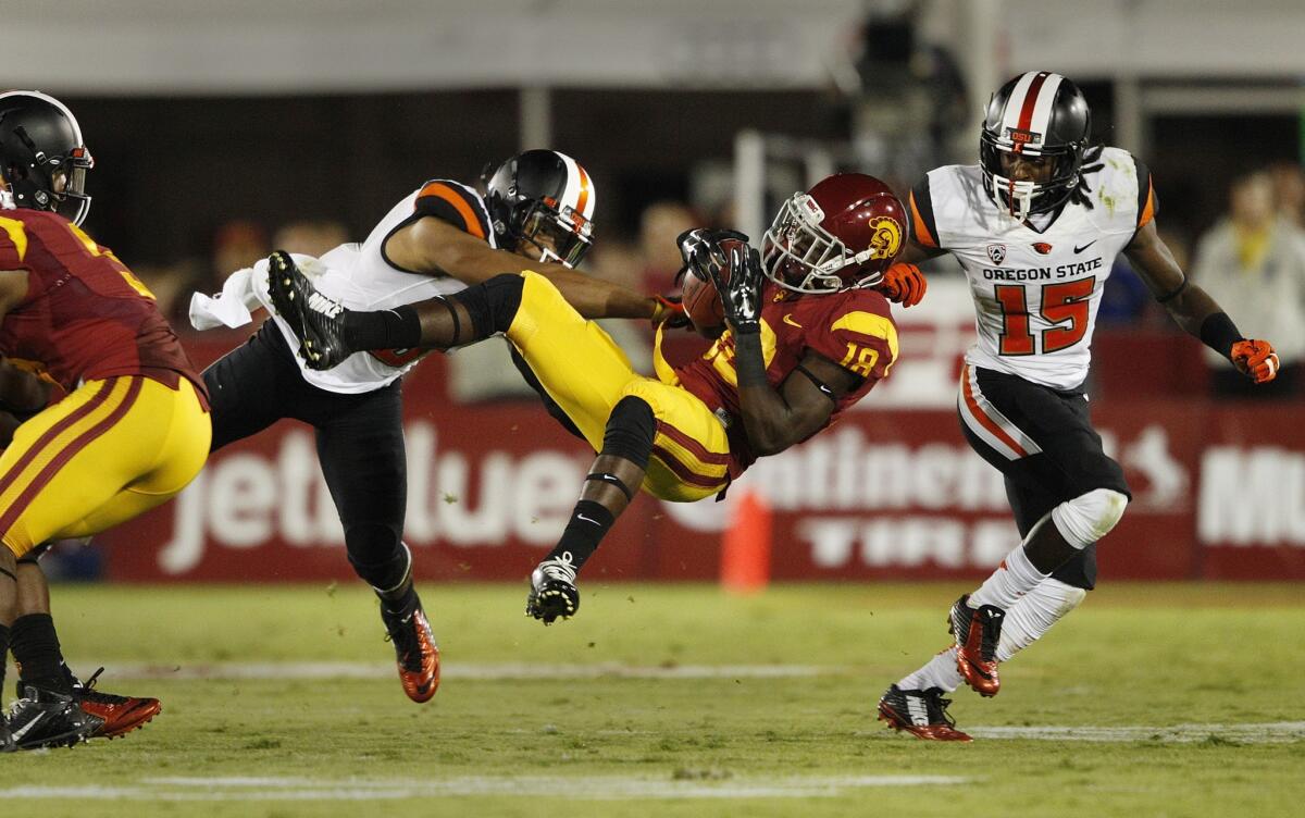 USC receiver Ajene Harris makes an acrobatic catch against Oregon State on Sept. 27. Harris will miss the Trojans' game Saturday against Arizona State because of a hamstring injury.