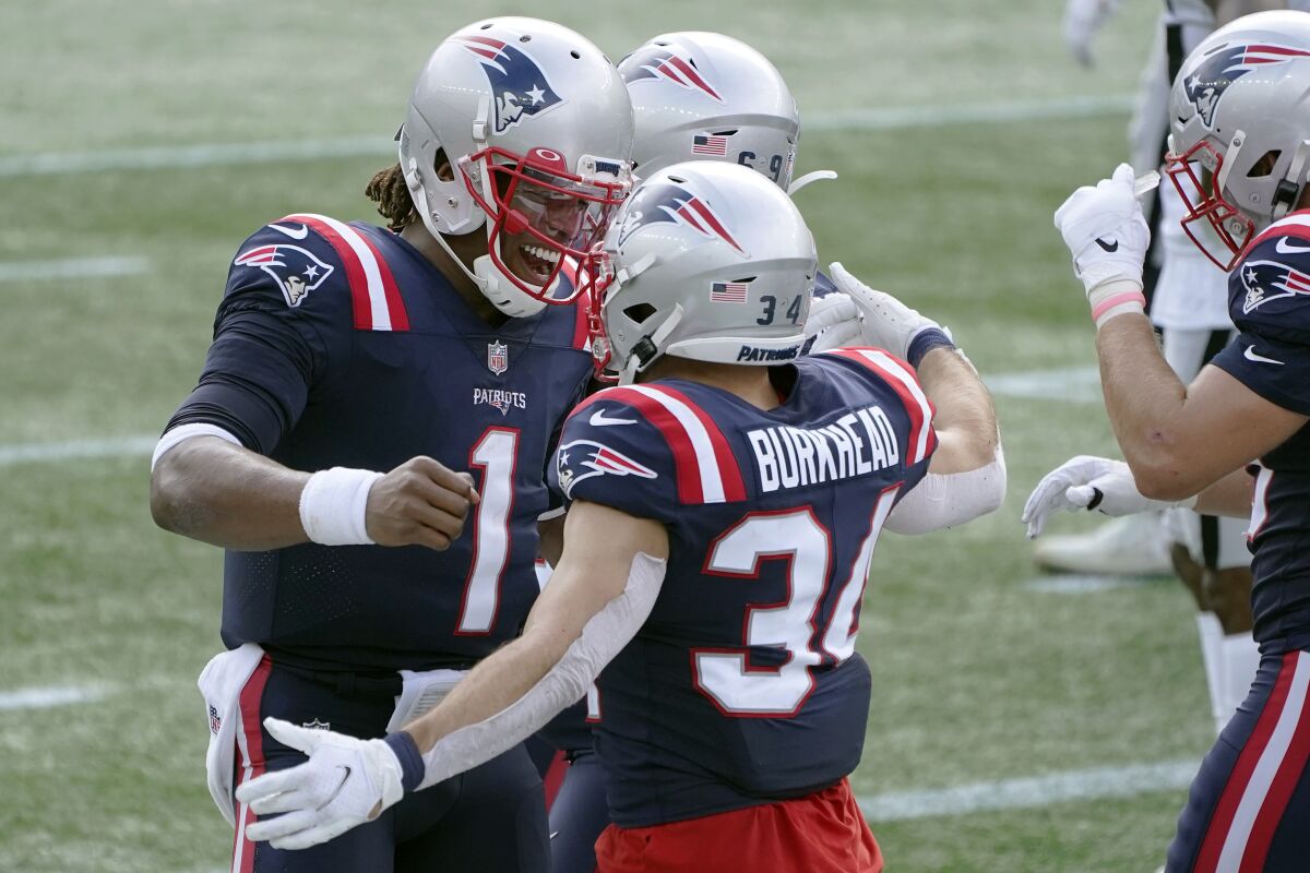 New England Patriots quarterback Cam Newton (1) celebrates his touchdown pass to running back Rex Burkhead (34) in the first half of an NFL football game against the Las Vegas Raiders, Sunday, Sept. 27, 2020, in Foxborough, Mass. (AP Photo/Charles Krupa)