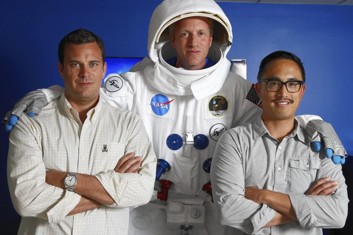AdColony's top managers -- Chief Revenue Officer Mike Owen, left, Chief Executive Will Kassoy and Nikao Yang, a senior vice president -- at the company's Los Angeles offices. Kassoy wears a spacesuit to symbolize the heights to which AdColony aspires in mobile advertising.