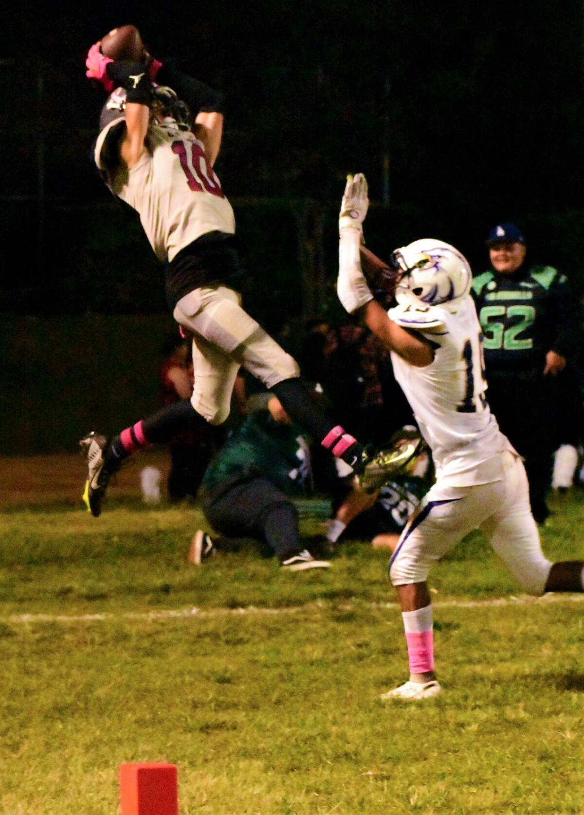 Garfield High's Jayden Barnes leaps high above a defender to make a catch.