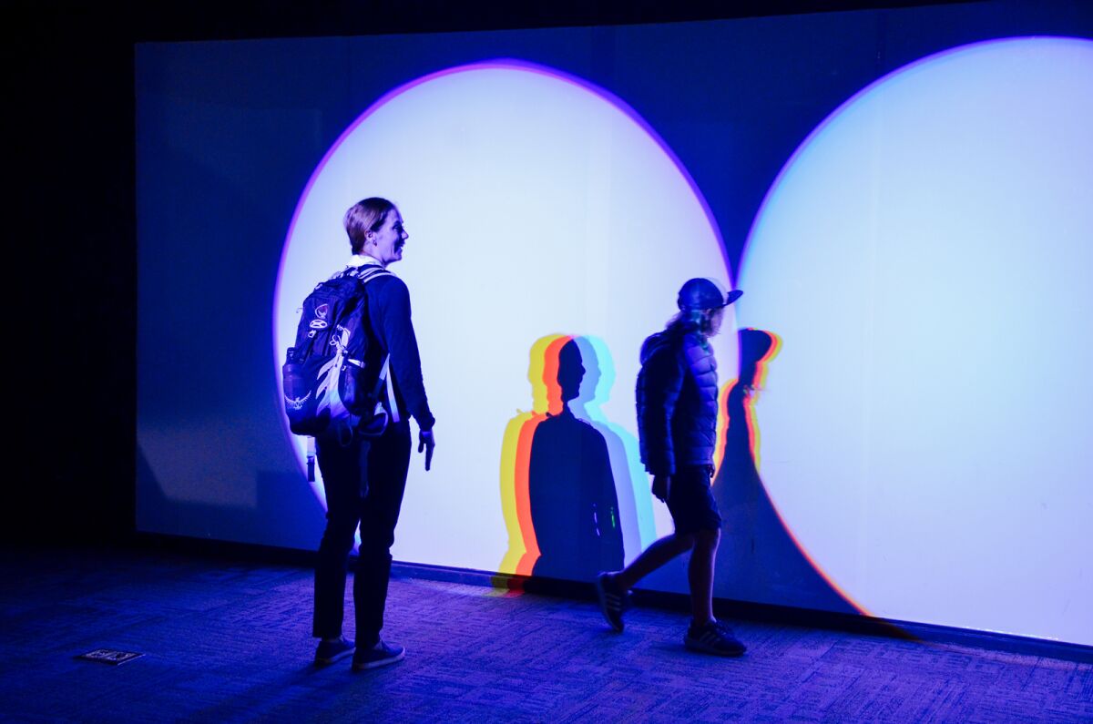 Visitors created colored shadows with light in the Fleet Science Center's "Flashback" exhibition.