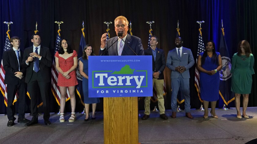 Winner of the Virginia Democratic gubernatorial primary, former Virginia Gov. Terry McAuliffe, center, addresses the crowd during an election party in McLean, Va., Tuesday, June 8, 2021. McAuliffe faced four other Democrats in Tuesday's primary. (AP Photo/Steve Helber)