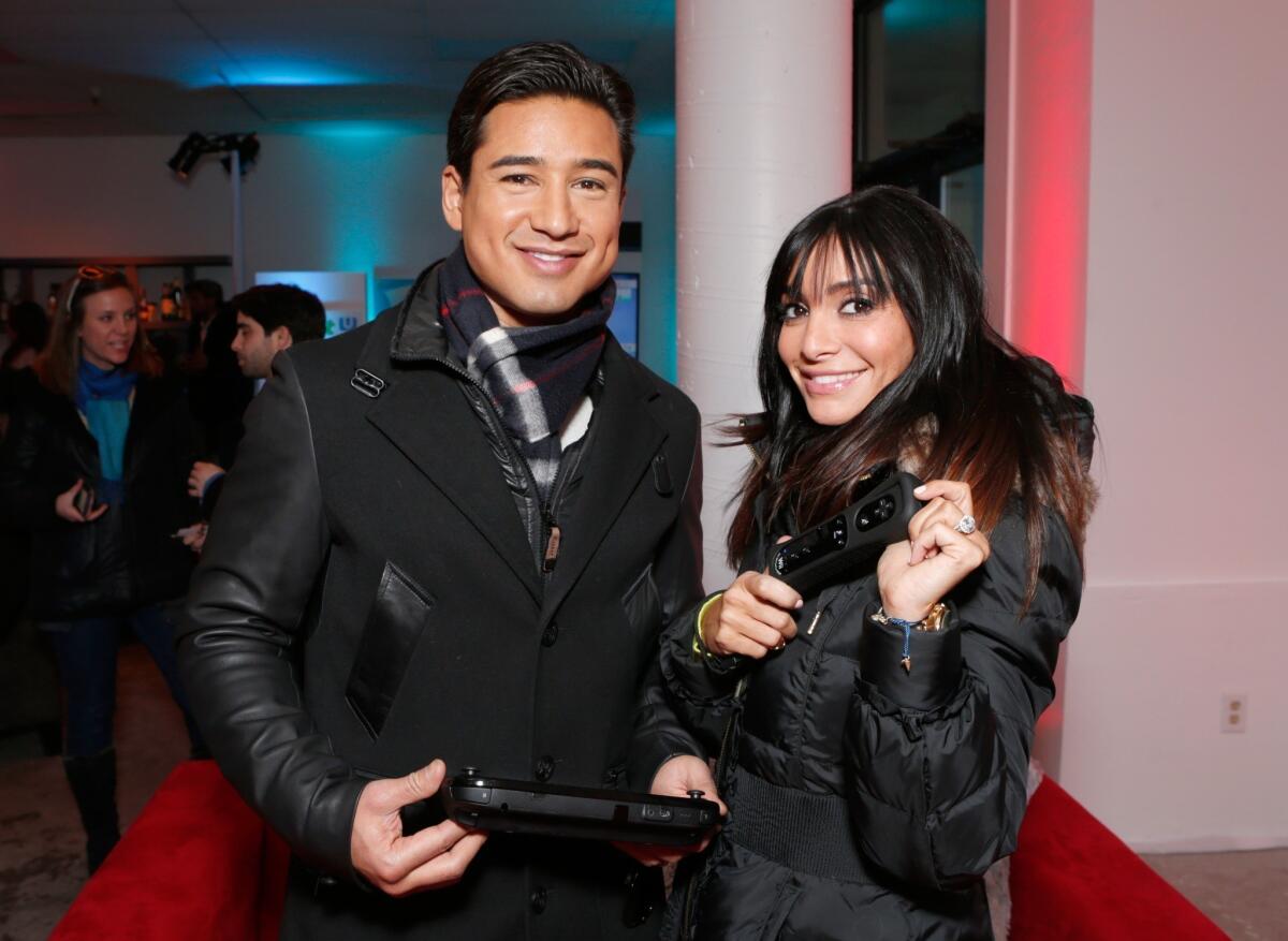 Mario Lopez, left, and Courtney Laine Mazza warm up at the Sundance Film Festival in January. They are expecting their second child.