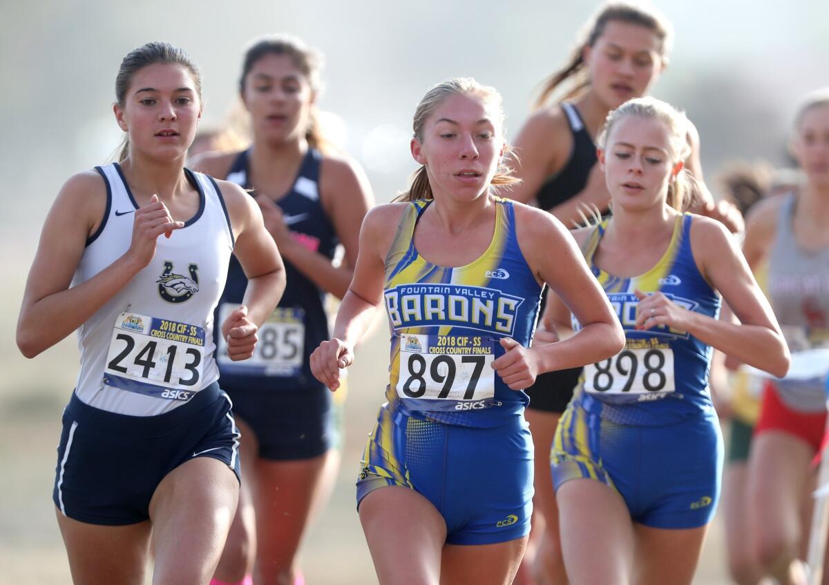 Fountain Valley's Ashley Faller, center, and Sara Feitz, right, run in the CIF Southern Section Division 1 finals at the Riverside City Cross-Country Course on Nov. 17, 2018.
