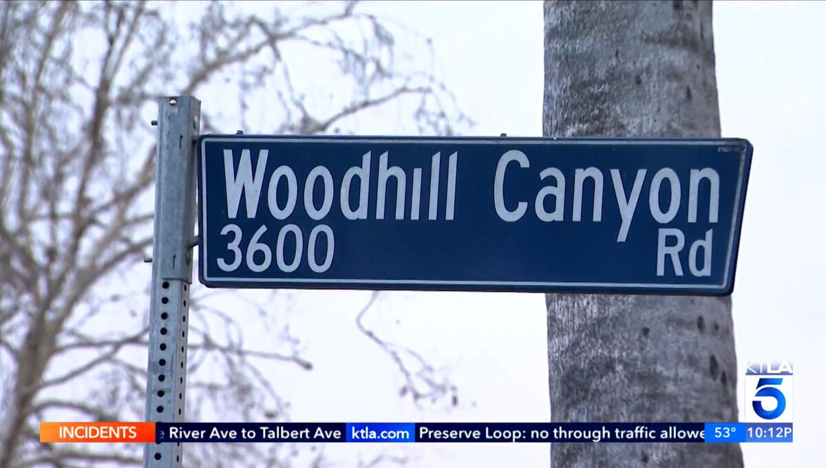 A street sign for Woodhill Canyon Road