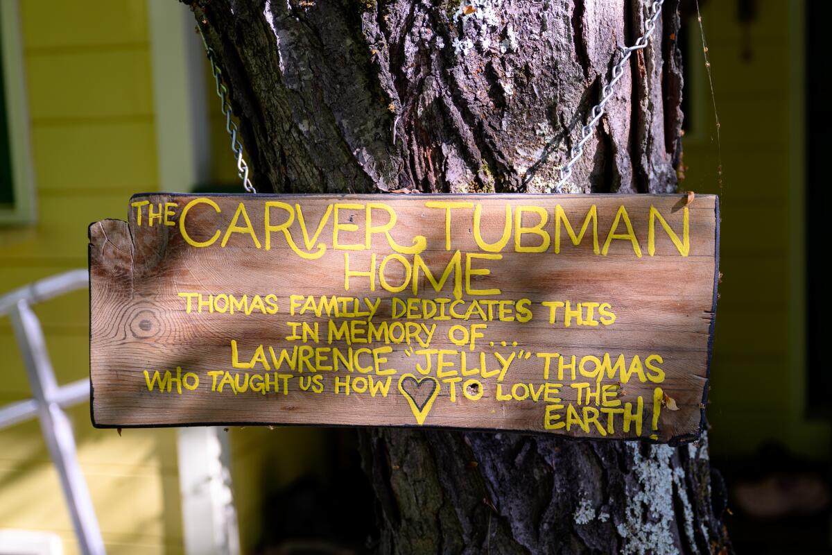 A sign honors George Washington Carver and Harriet Tubman at EarthSEED Farm.