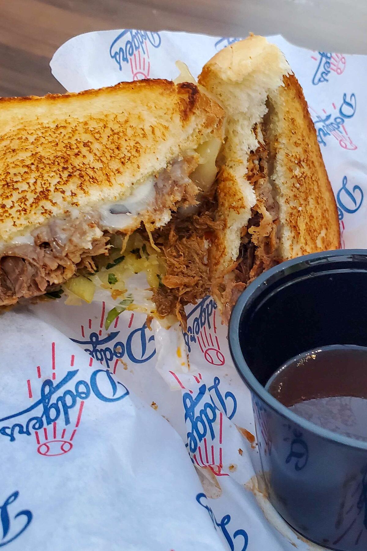 The new birria grilled cheese at Dodger Stadium served with a cup of consommé.