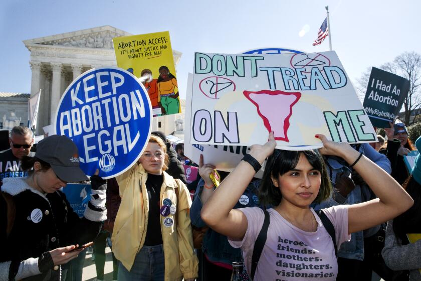 Abortion rights demonstrators including Jaylene Solache, of Dallas, Texas, right, rally, Wednesday, March 4, 2020, outside the Supreme Court in Washington. (AP Photo/Jacquelyn Martin)