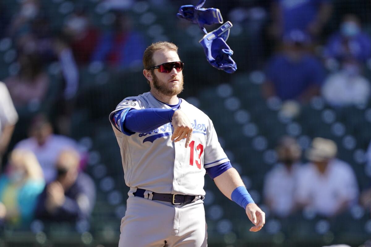 Dodgers infielder Max Muncy tosses his batting gloves after striking out against the Seattle Mariners on April 20.
