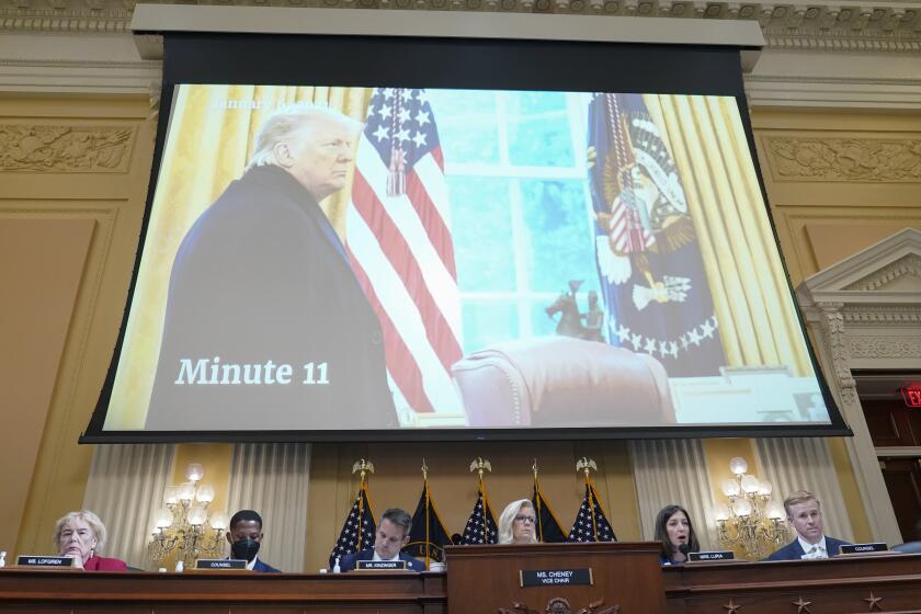 A photo of President Donald Trump, taken as he entered the Oval Office after speaking at the rally on the Ellipse on Jan 6, is displayed, as the House select committee investigating the Jan. 6 attack on the U.S. Capitol holds a hearing at the Capitol in Washington, Thursday, July 21, 2022. (AP Photo/Patrick Semansky)