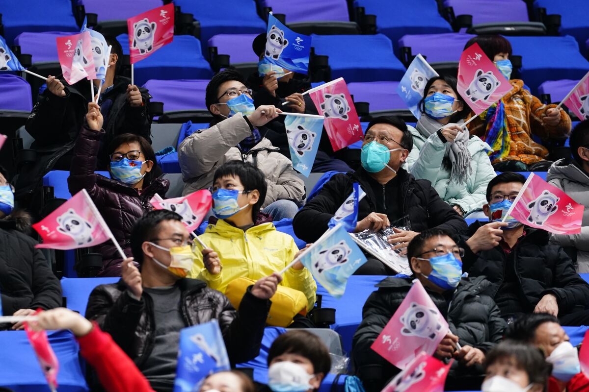 Spectators cheer during a preliminary round men's hockey game between China and Canada at the 2022 Winter Olympics, Sunday, Feb. 13, 2022, in Beijing. (AP Photo/Matt Slocum)