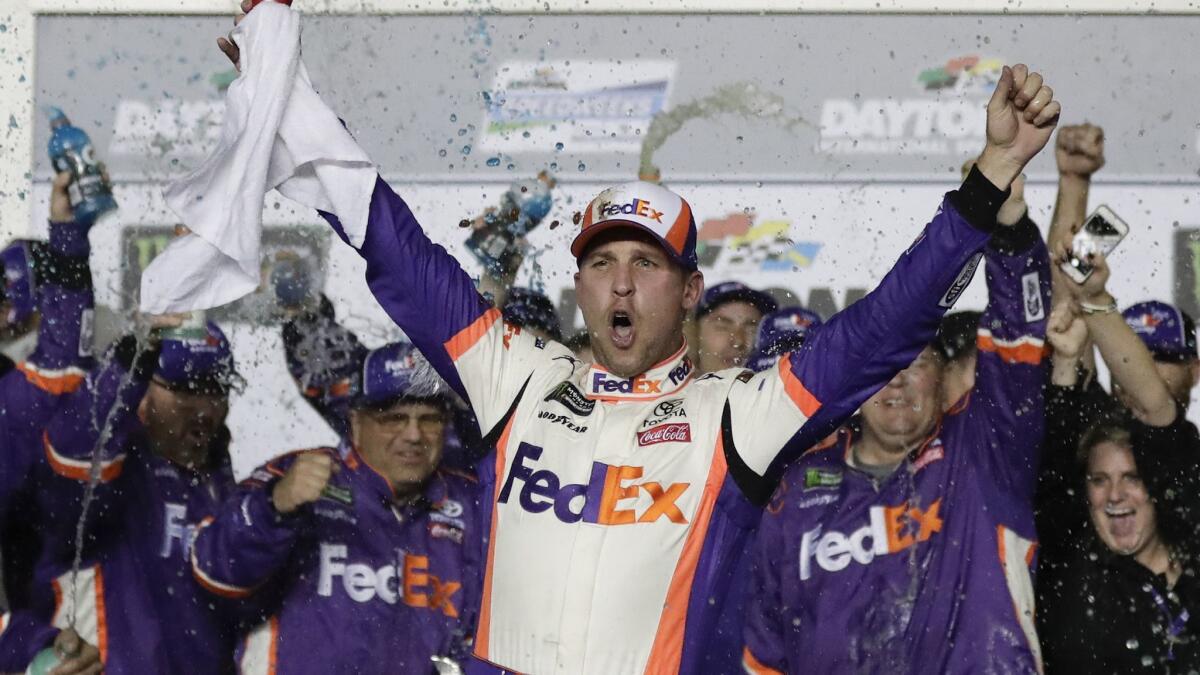 Denny Hamlin celebrates in Victory Lane after winning the Daytona 500 on Sunday.